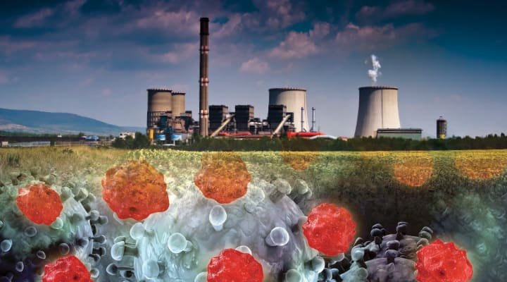 A composite image depicting a scene of industrial pollution. In the background, there's a power plant with multiple cooling towers emitting steam and a tall chimney releasing smoke into the sky. The plant is set against a pastoral landscape with green fields under a blue sky with some clouds. In the foreground, there are magnified particles representing pollutants, with a mix of what appears to be microscopic views of particulates and possibly bacteria or viruses. The particles are rendered in shades of gray, white, and red, symbolizing contamination. This image is likely intended to convey the impact of industrial activity on air quality and the environment.